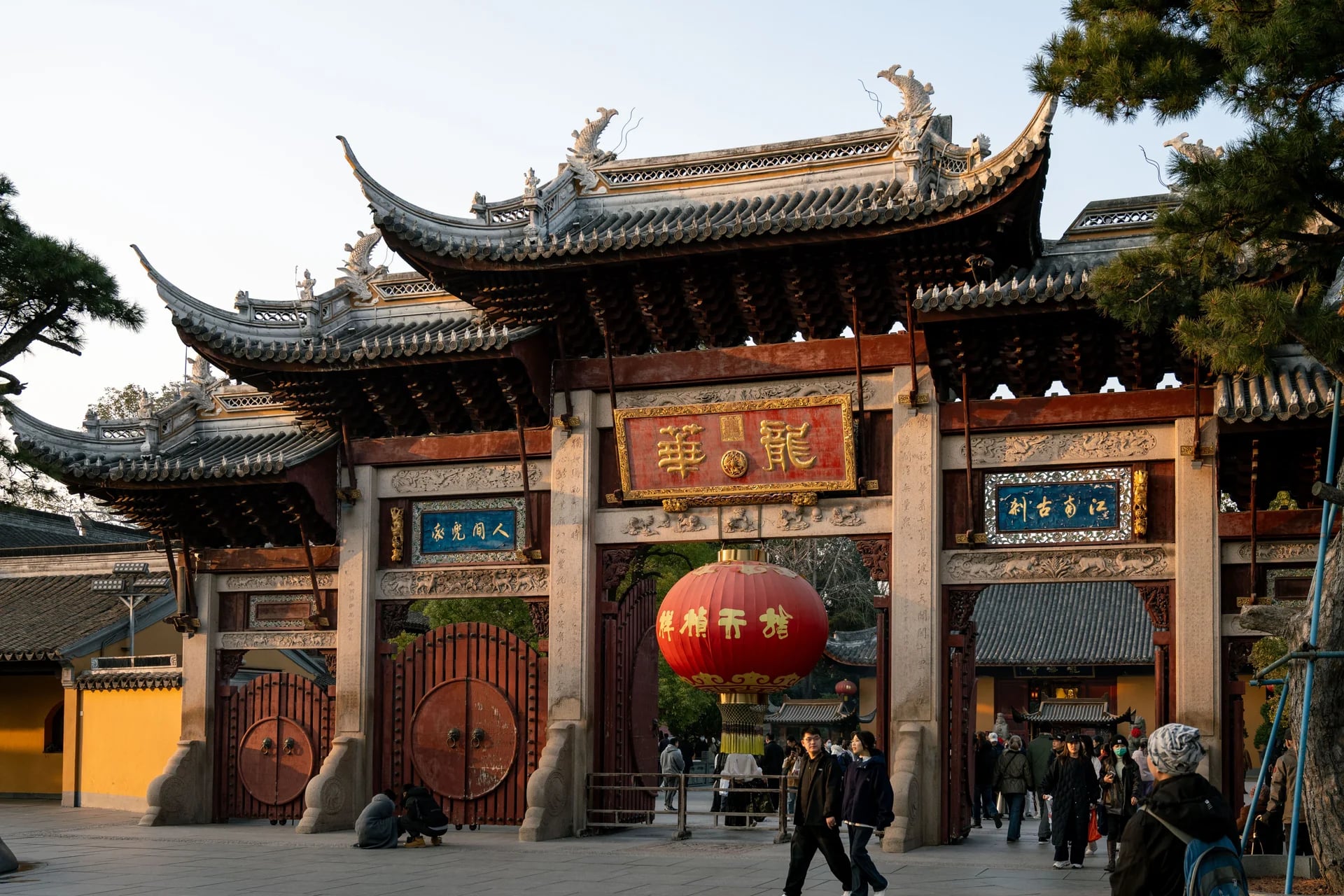 Traditional Chinese temple gate captured during golden sunset in Shanghai